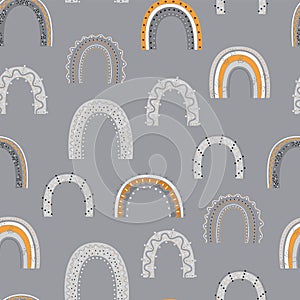 Seamless pattern with hand drawn rainbows on gray background.