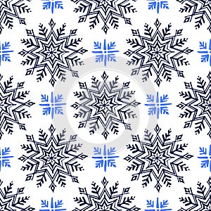 Seamless pattern with hand drawn snowflakes isolated on white