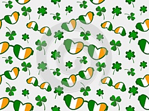 Seamless pattern for the Irish holiday St. Patrick's Day with glasses and hearts and the Irish flag. Glasses are