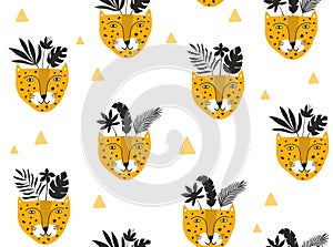 Seamless pattern with leopard cute faces and silhouets of tropical leaves and flowers. photo