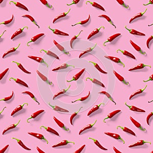 Seamless pattern made of red chili or chilli on pink background. Minimal food pattern. Red hot chilli seamless peppers pattern.