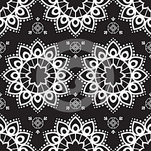 Seamless pattern mehndi background with flowers in indian style with lace buta decoration items on black background.