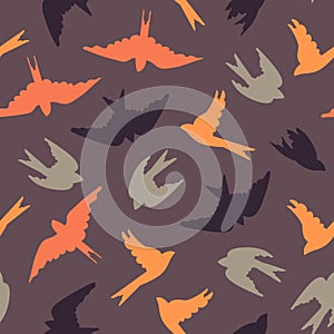 Seamless pattern with migrating birds. Colored birds on a purple background. Surface design.