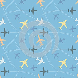 Seamless pattern with multicolored passenger airplanes and flight paths