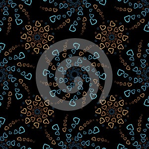 Seamless pattern of orange and blue hearts flowers on a dark background. Print with hearts in kaleidoscopic ornamental style