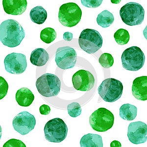 Seamless pattern with painted watercolor green polka dots