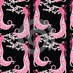 Seamless pattern of peacocks on flowering tree branch photo