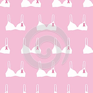 Seamless pattern with pink cancer ribbons on bras. Breast Cancer Awareness Month pink and white background. Cancer ribbon symbol.