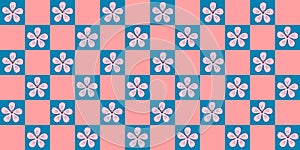 Seamless pattern with pink sakura or cherry blossom flowers on checked pink and blue background