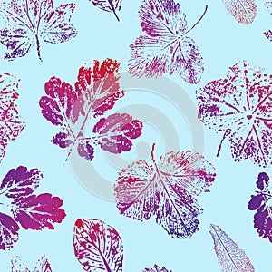 Seamless pattern of prints of red-blue leaves on a blue background. Vector