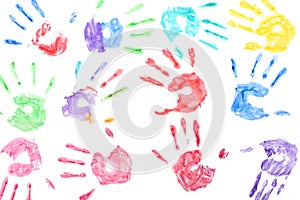 Seamless pattern with rainbow colored kids hand prints on white background