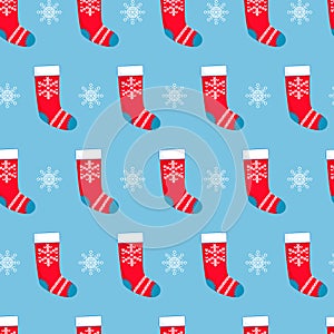 Seamless pattern with red Christmas stockings and snowflakes on blue background. Christmas, winter concept for wrapping, wallpaper