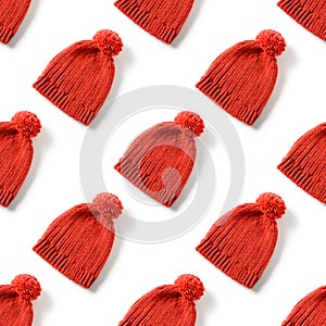 Seamless pattern of red knitted hat for winter season isolated on white background.