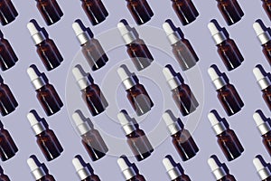Seamless pattern of serums with collagen on purple background photo