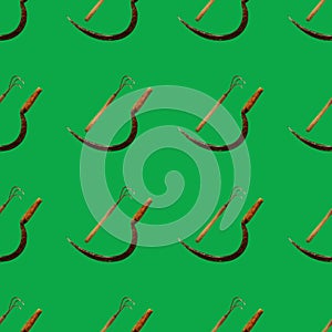 Seamless pattern with sickle,hoe on green background