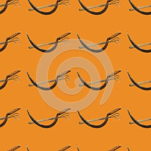 Seamless pattern with sickle,hoe on orange background