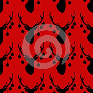 Seamless pattern with silhouette of deer head christmas tree toys on horns red background.