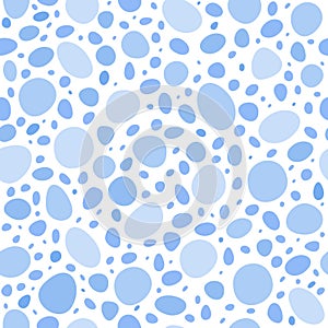 Seamless pattern of spots of different sizes and shades of blue, on a light background .