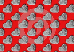 Seamless pattern with stone hearts on red