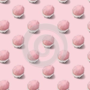 Seamless pattern of two-tone white and pink marshmallows on a pink background