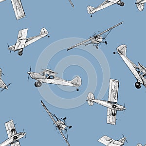 Seamless pattern of various drawn retro airplanes in flight in blue sky