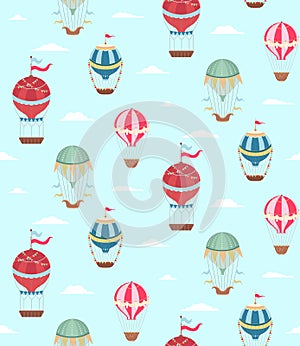 Seamless pattern with vintage hot air balloons with ribbons and flags on blue background with cloud.