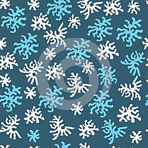 Seamless pattern with white and blue snowflakes. Winter abstract elements for decoration of fabric, paper