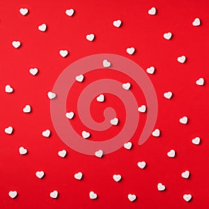 Seamless pattern. White hearts on red background. Top view. Valentine's Day. Love, date, romantic concept. Square crop