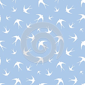 Seamless pattern with white swallows on blue. Vector illustration.