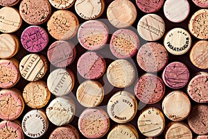 A seamless pattern of wine corkage, arranged in an artistic display on the wall, showcasing different colors and textures. th photo