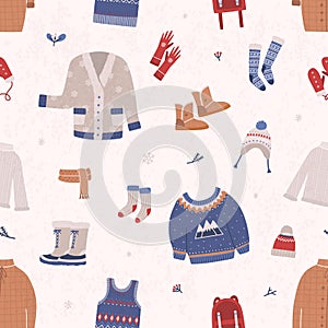 Seamless pattern with winter clothes and outerwear on light background. Backdrop with warm seasonal clothing or apparel