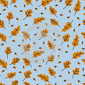 Seamless pattern with yellow oak leaves and acorns on blue background. Autumn concept