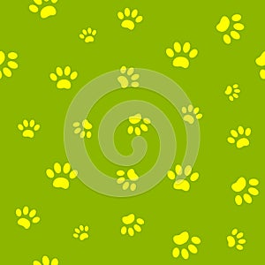 Seamless pattern of yellow paw prints on green background.