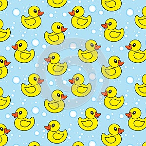 Seamless pattern with yellow rubber ducks and soap bubbles on blue background.