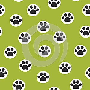 Seamless pet paw pattern. Cat or dog footprint on green background.