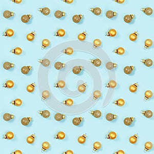Seamless regular creative pattern with bright shiny little Christmas balls on blue paper