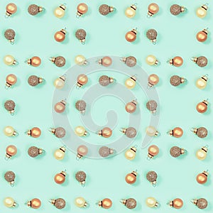 Seamless regular creative pattern with bright shiny little Christmas balls on mint colored paper