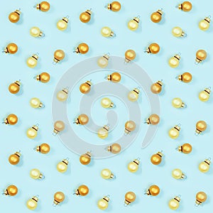 Seamless regular creative pattern with gloden shiny small Christmas balls on blue paper