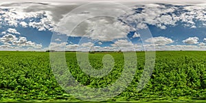 Seamless spherical hdri 360 panorama among green farming fields in summer day with awesome clouds in blue sky in equirectangular