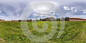 Seamless spherical hdri panorama 360 degrees angle view near brick wall of ruined castle with halo in sky in equirectangular