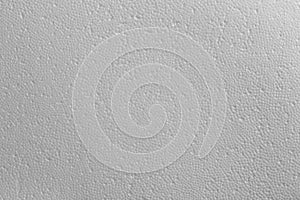 Seamless texture of white polystyrene foam or styrofoam, close-up flat white on white background photo