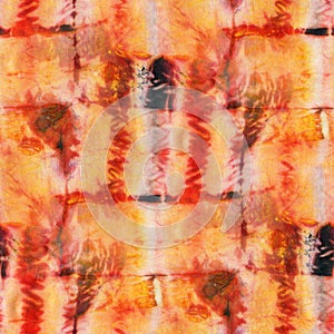 Seamless tie-dye pattern of orange and red color on white silk