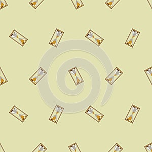 Seamless vector pattern. Chaotic background with gold sandglasses on the beige backdrop
