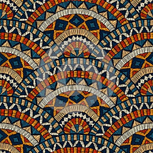 Seamless wavy embroidered pattern. Handmade. Blue, black, white and orange colors. Prints for textiles. Ethnic and tribal motifs.