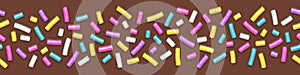 Seamless wide background of chocolate with sprinkles