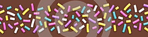 Seamless wide background of chocolate with sprinkles photo