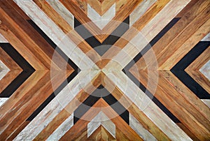 Seamless yellow, black, white and dark brown color lumber in arrows or chevron pattern to the center for texture background