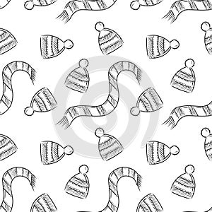 Seamlesspattern with wither hand knitted striped hat and scarf in black onwhite background. Hand drawn sketch vector illustration photo