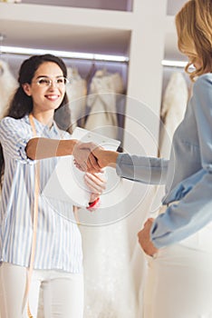 Seamstress and bride shaking hands