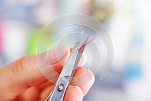 Seamstress cutting the thread with scissors